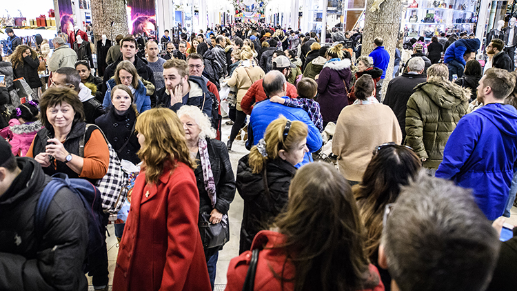 crowd of people in winter jackets in an indoor mall
