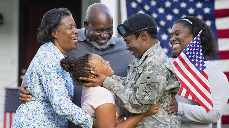 Waist-length view of an African-American family greeting a returning female soldier, Richmond, Virginia