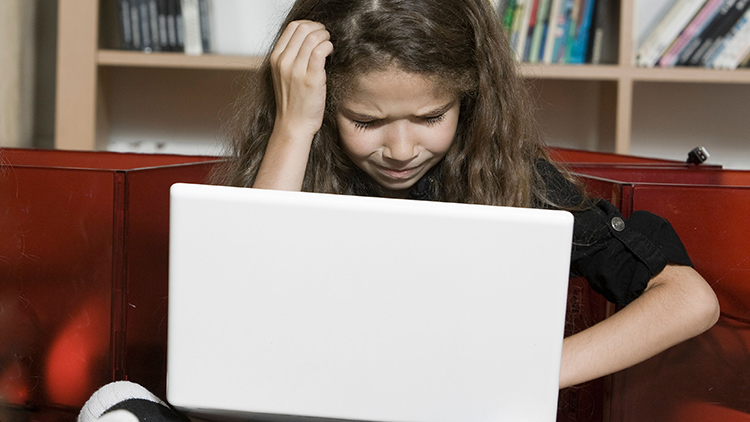 Upset child on laptop