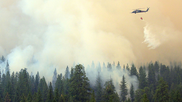 California Air National guardsmen from the 129th Rescue Wing perform precision water bucket drops