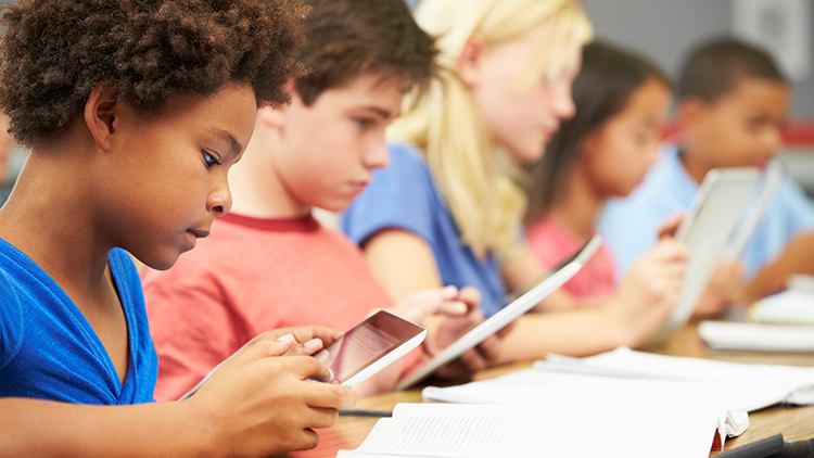 Pupils In Class Using Digital Tablet