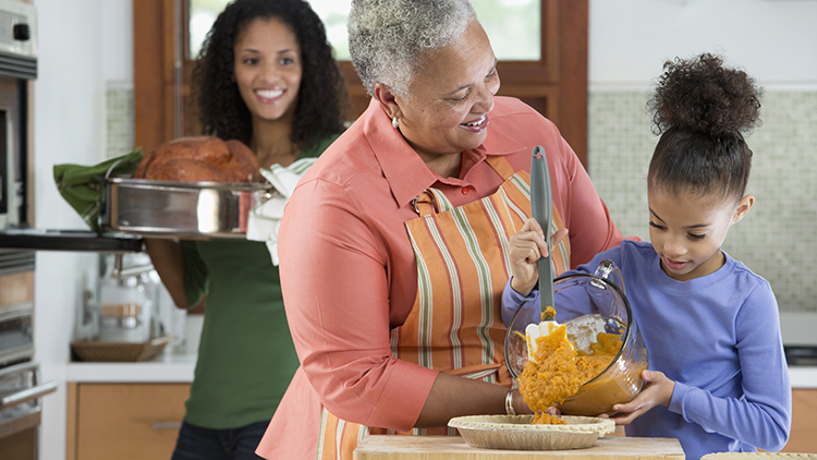 Three generations of women making Thanksgiving dinner
