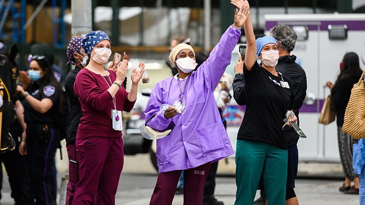 Medical workers stand outside NYU Langone Health hospital