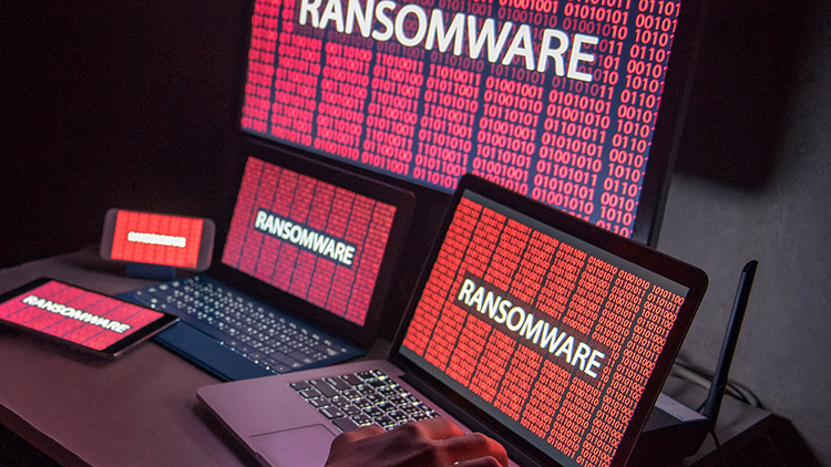 Computers with red screens and the word "Ransomware" on it